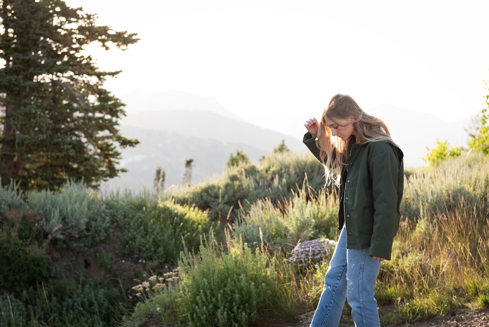 woman standing on ground with plants