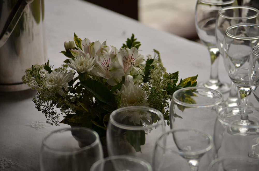 empty wine glasses beside flower centerpiece