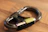 Close-up of the black quickdraw keyring clipped onto a leather belt.