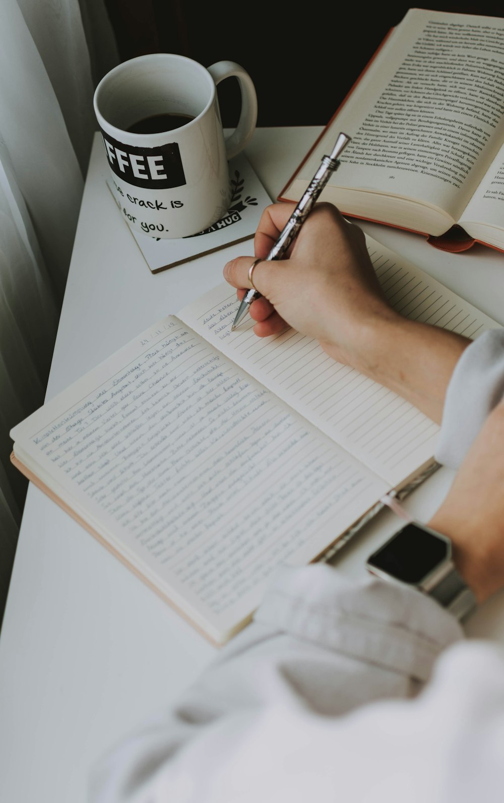 woman writing down on notebook