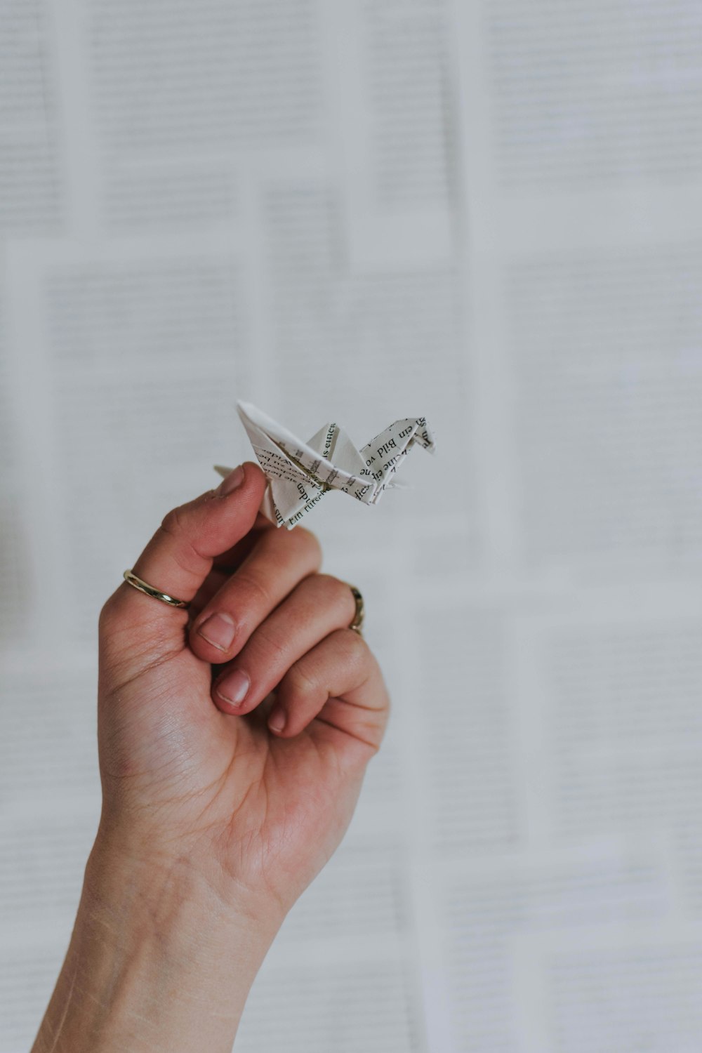 a person holding a paper airplane in their hand