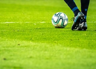 man playing soccer game on field