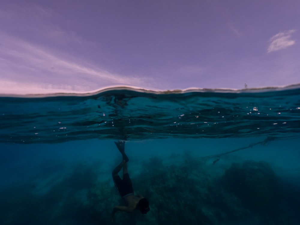 man swimming on the body of water photograph