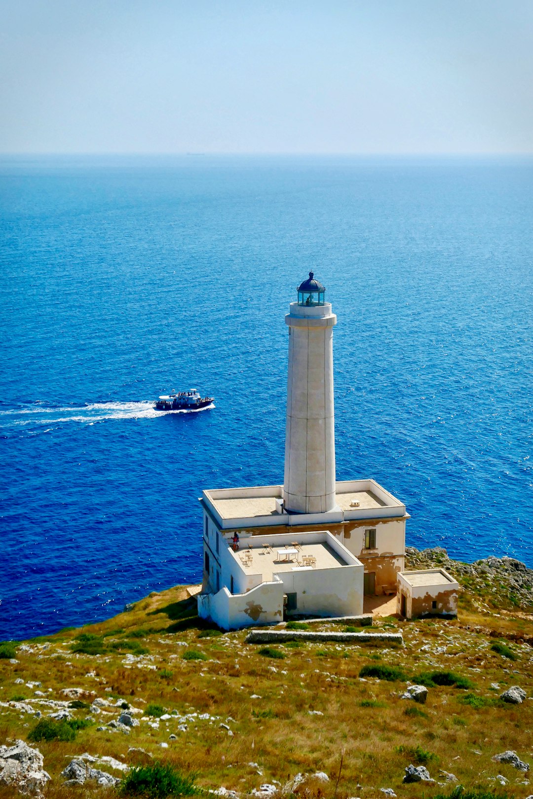 white lighthouse front of sea