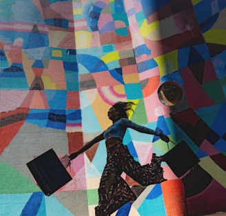 woman holding bag beside mural painting