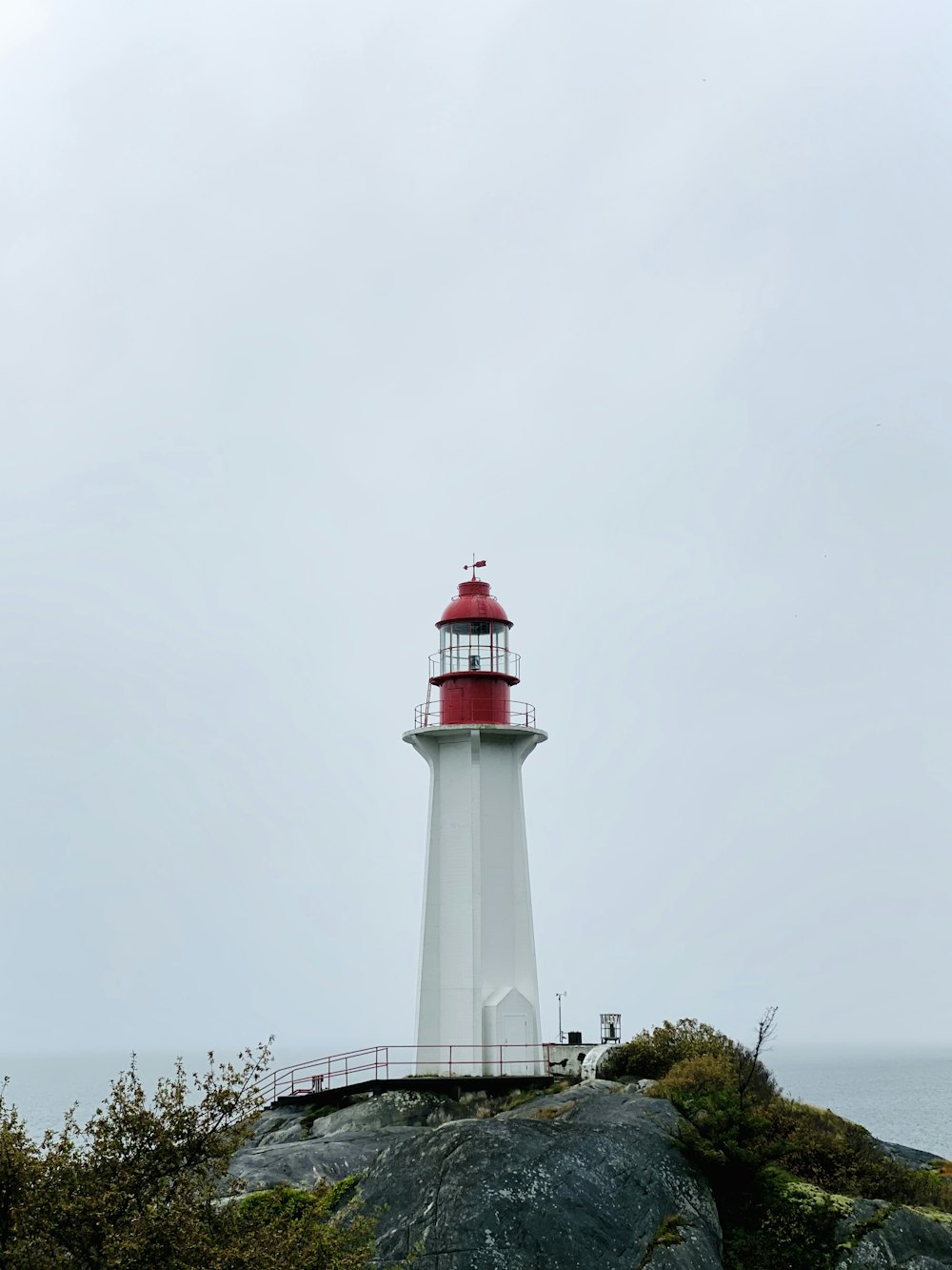 white and red lighthouse during daytime