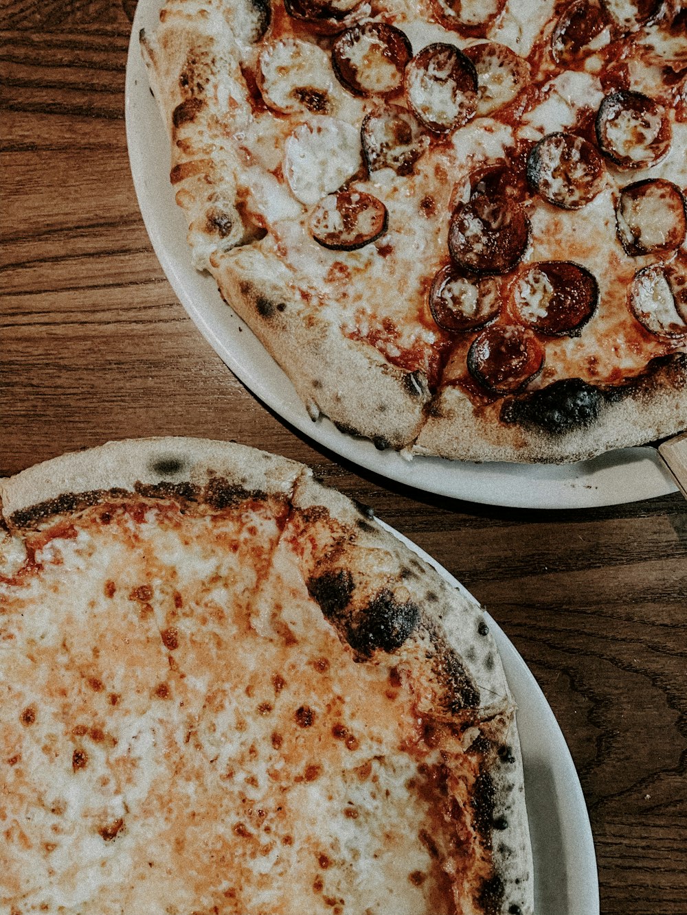 two cooked pizzas