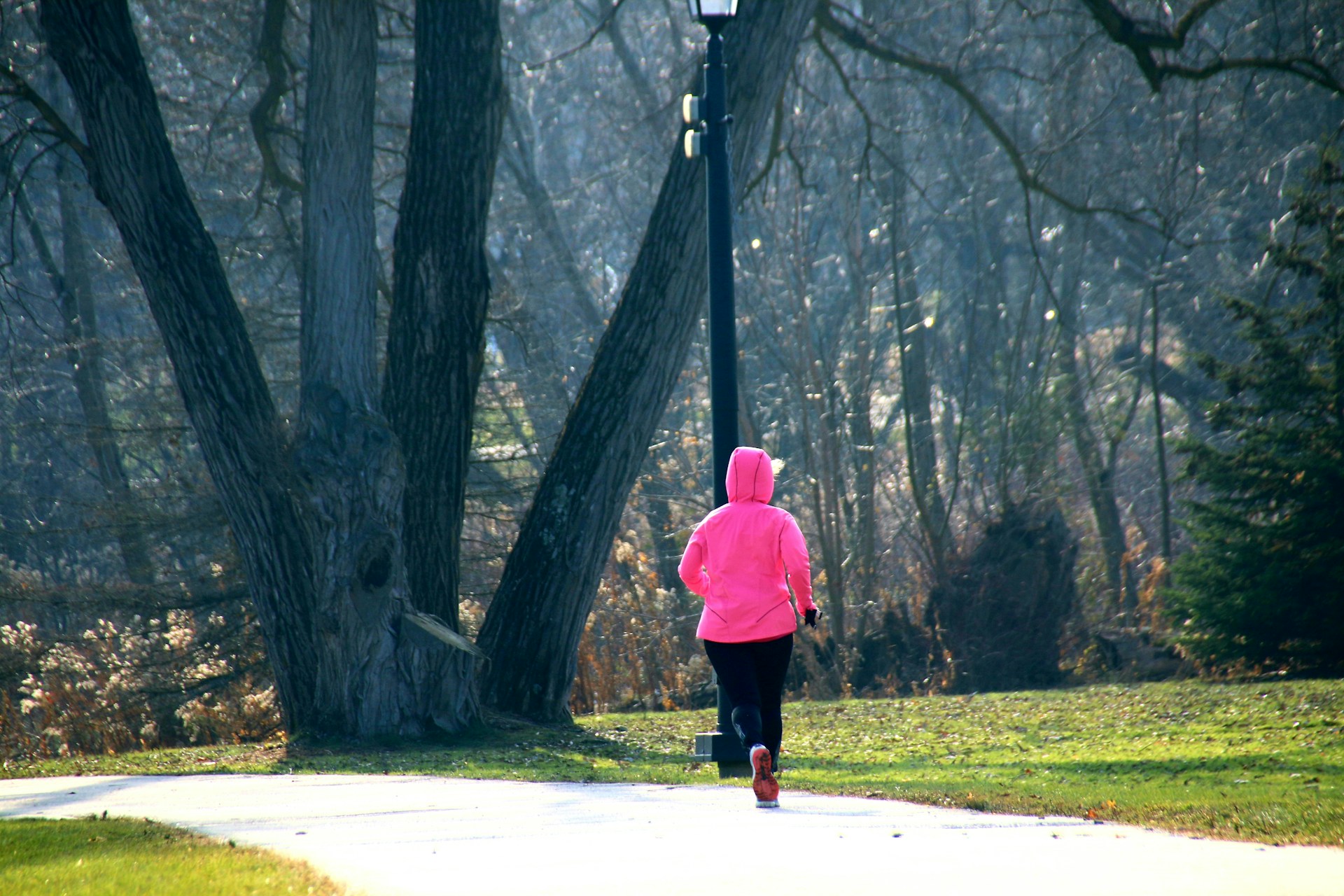 A person wearing a comfortable hoodie while exercising outdoors in a park.