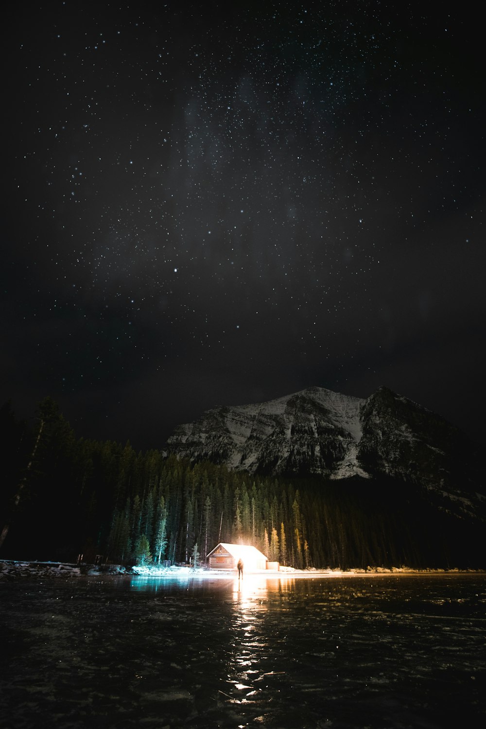 person standing beside shack