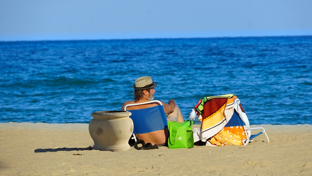 man sitting on seashore