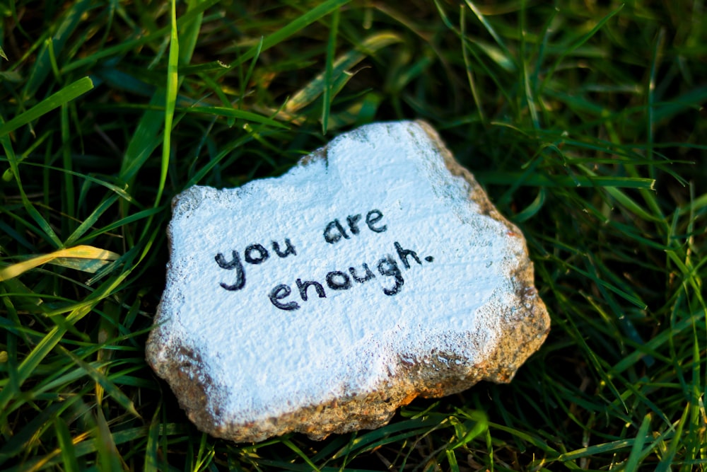 a rock with the words you are enough written on it