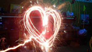 Romantic burning heart fire display at a wedding celebration.