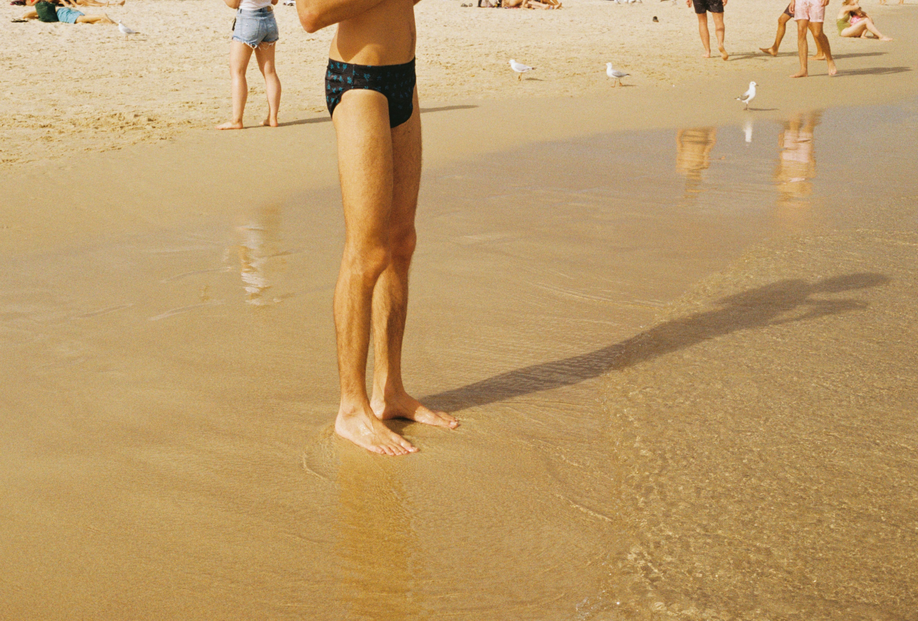 man in speedo on beach