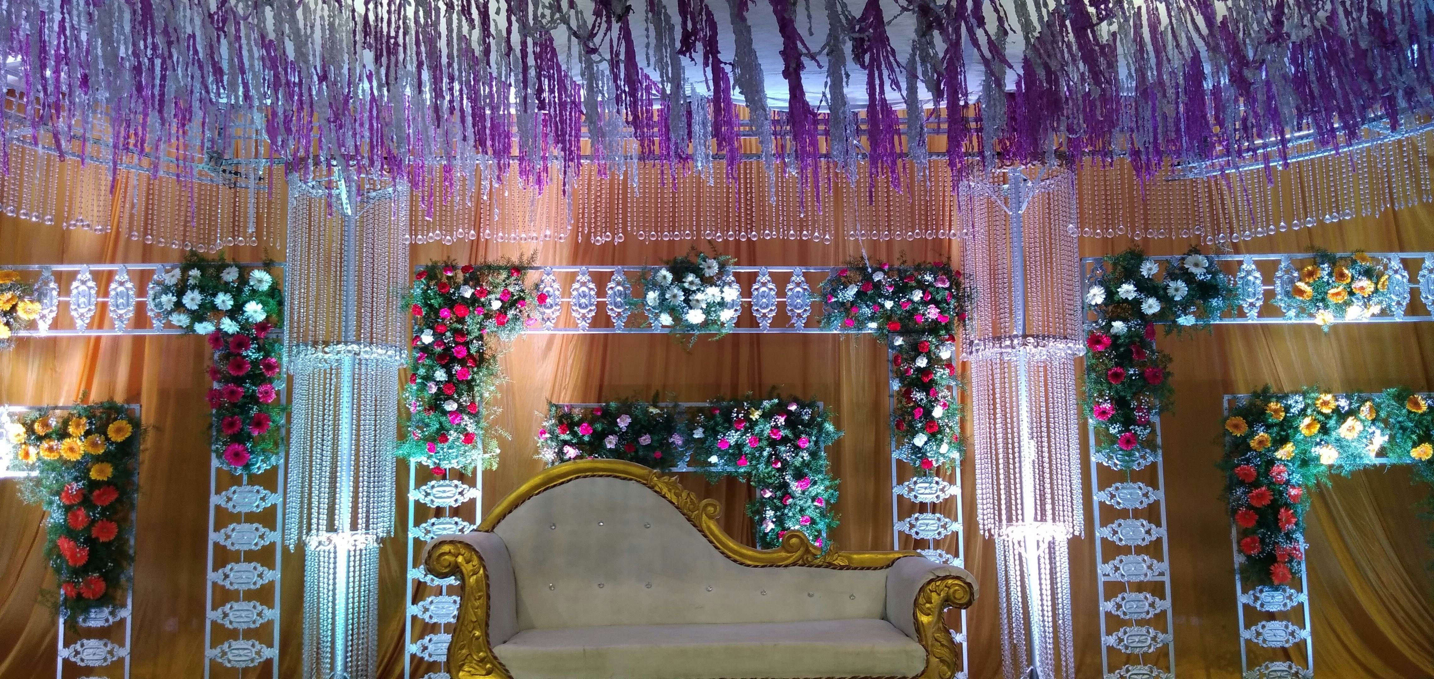 Crystal-adorned wedding pavilion with dramatic lighting and ornate stage setup