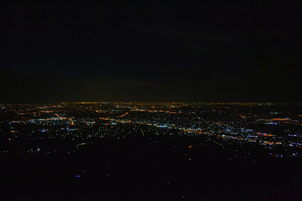 a view of a city at night from an airplane