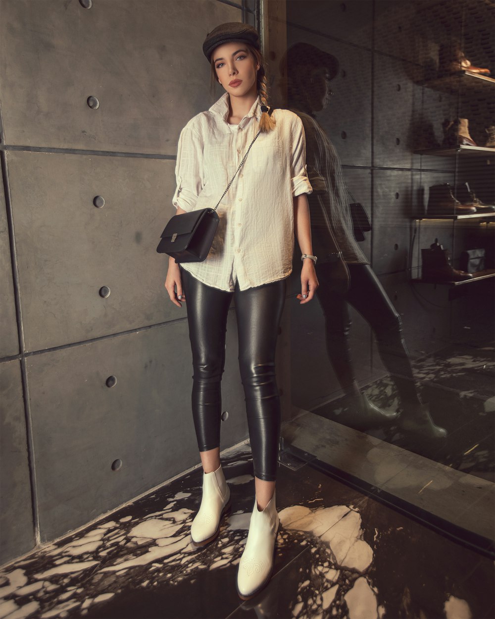 Woman wearing white dress shirt and black leather leggings photo