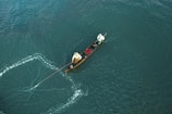 Local fishermen practicing sustainable fishing techniques on a boat.