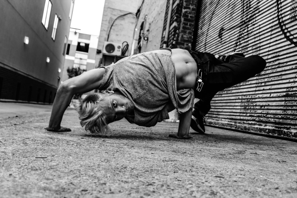 man flexing his body on ground