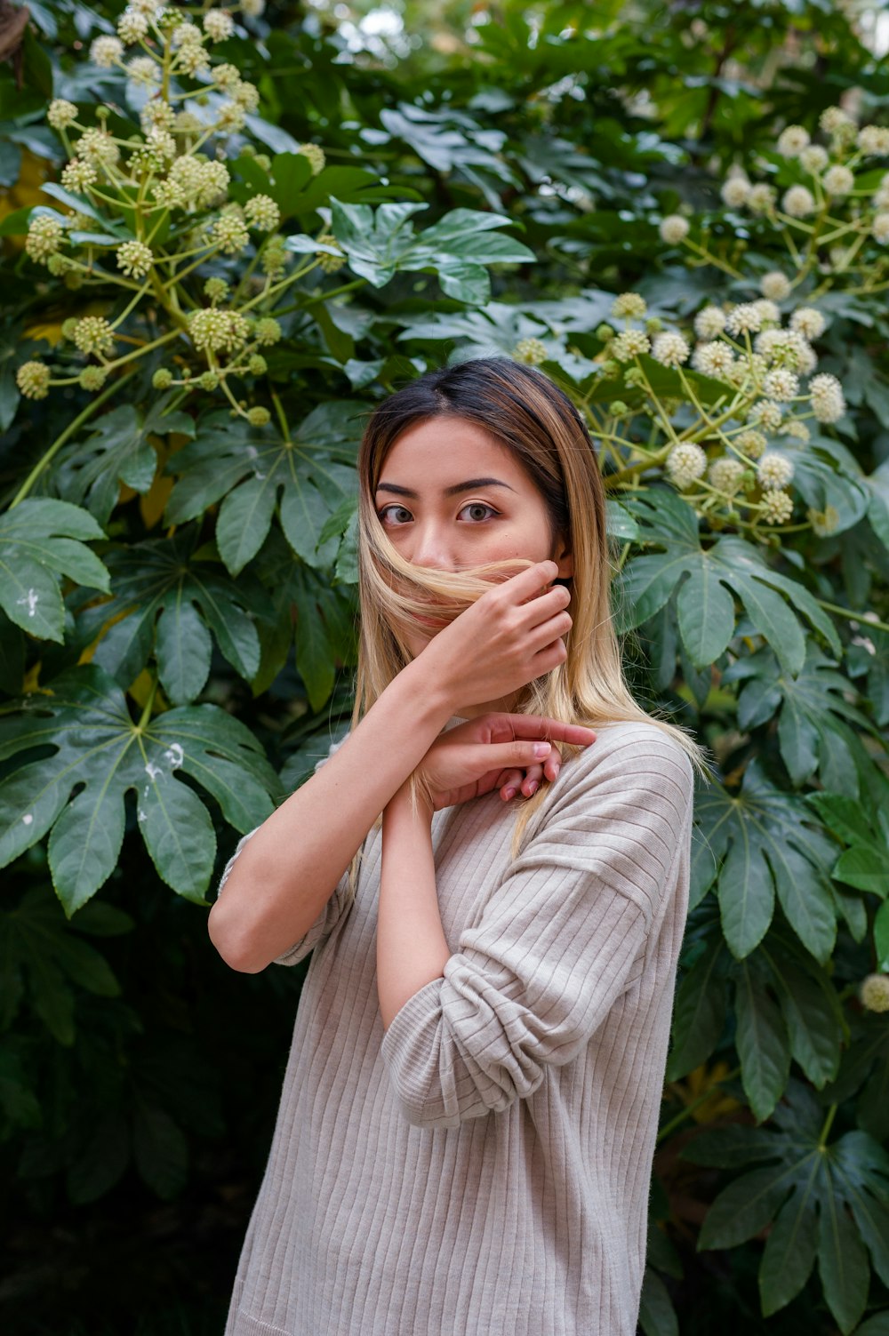 woman standing in front of green plant