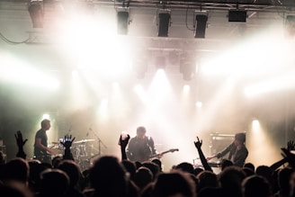 Band performing live on stage with dynamic lighting and engaged audience