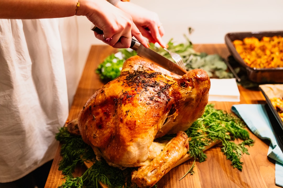 person about to slice the roasted chicken,