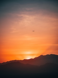 A breathtaking sunset over a serene landscape, symbolizing the beauty of travel.