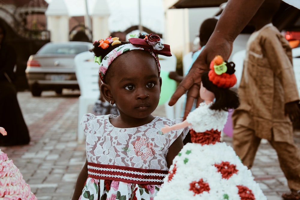 woman standing beside doll