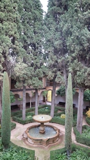 Maintenance staff attending to a charming courtyard garden, ensuring a peaceful atmosphere.