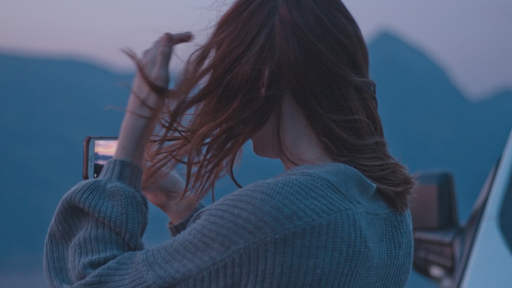 a woman taking a picture of herself with her cell phone