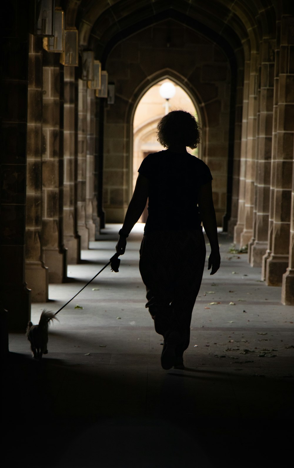 silhouette of woman walking to hallway