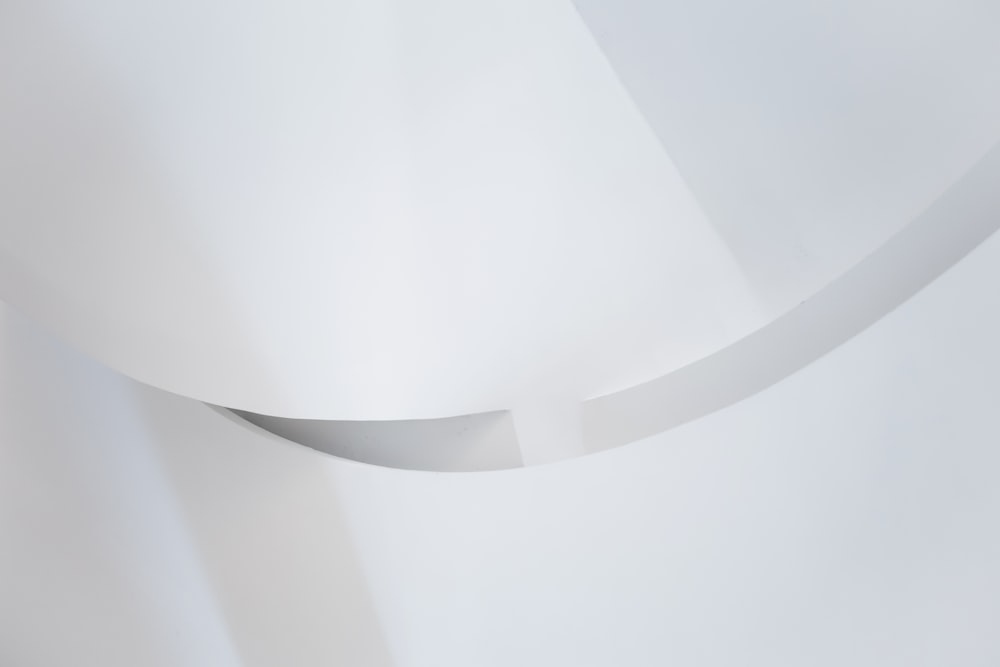 a close up of a white wall with a curved corner