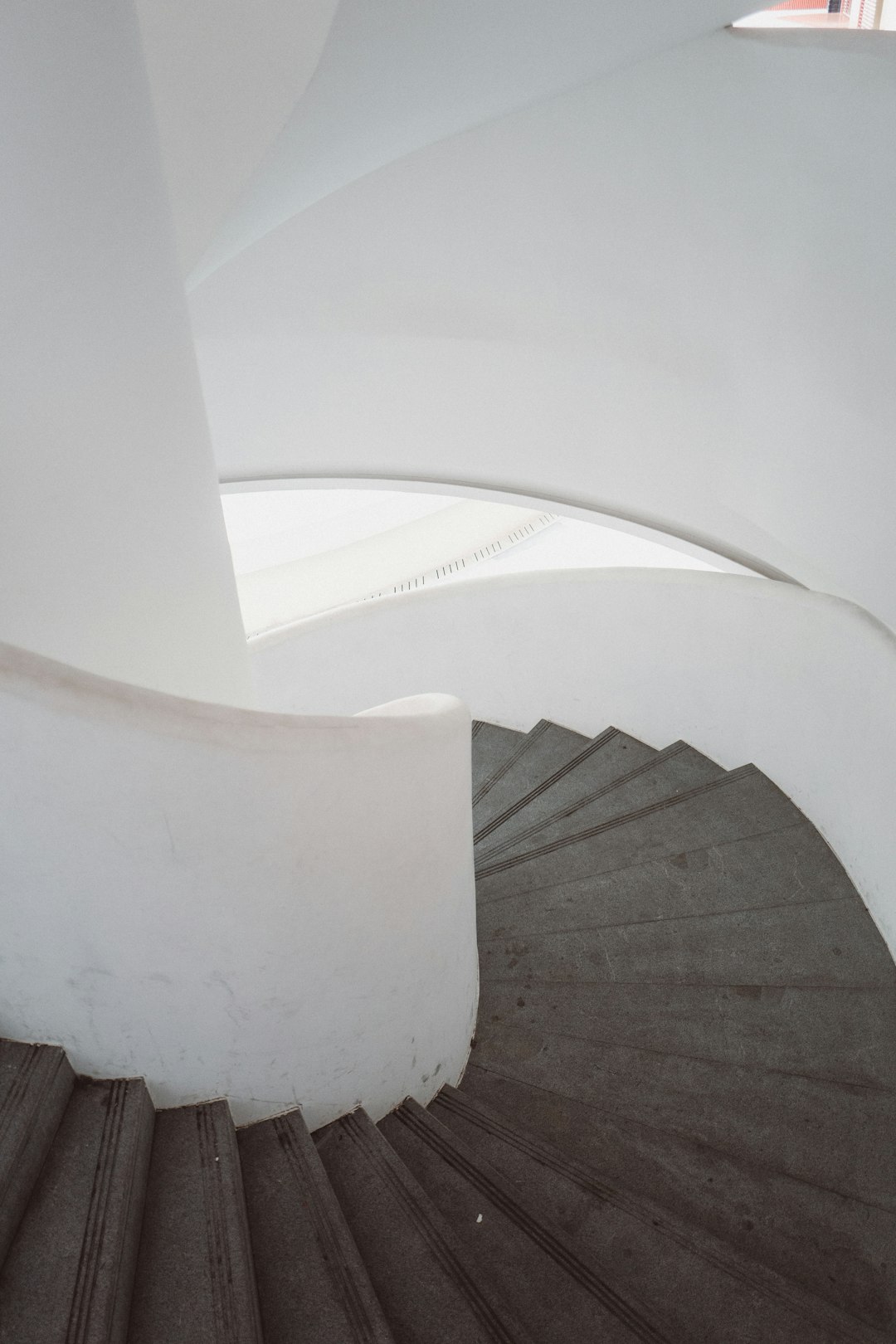 gray and white concrete spiral staircase