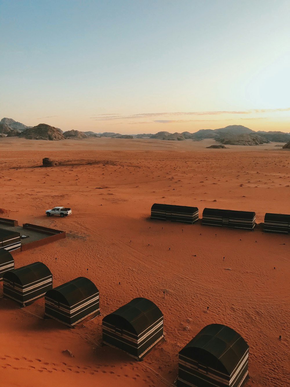 a desert with a bunch of beds in the middle of it