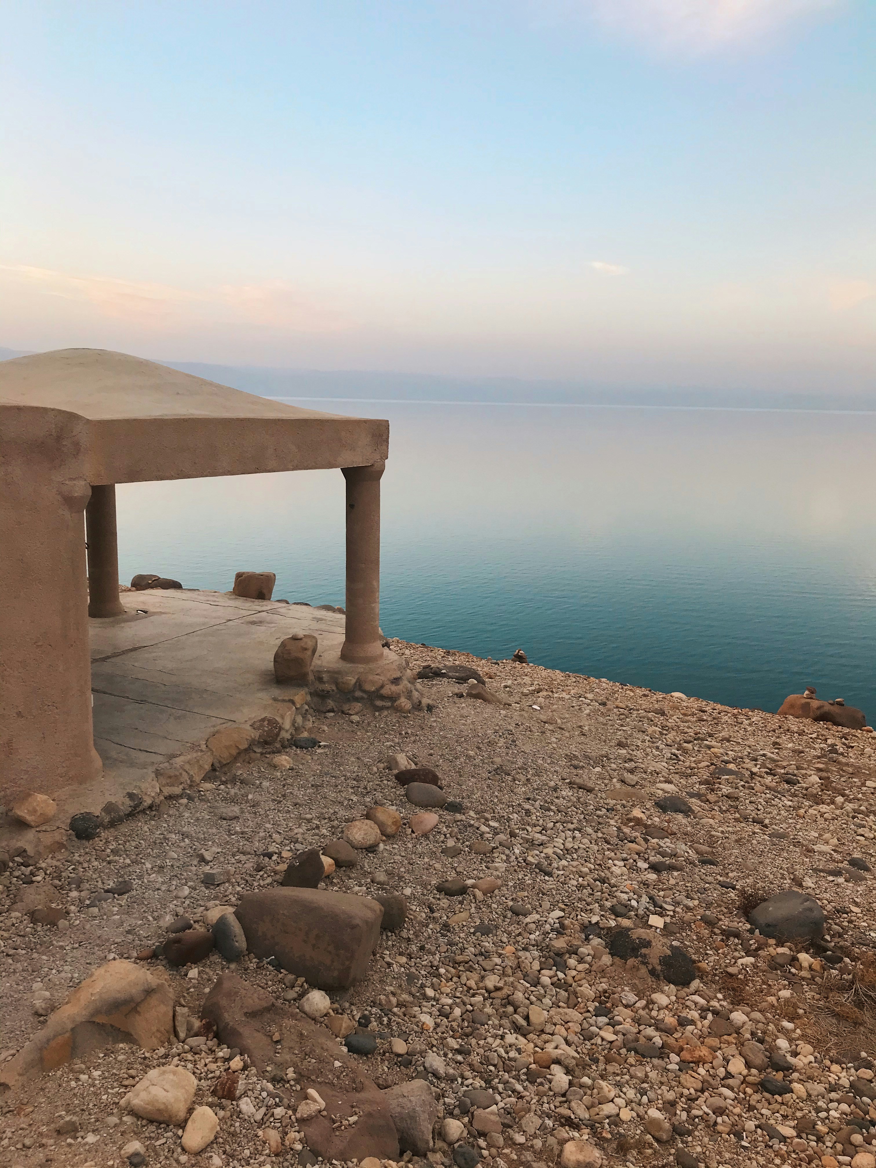 a stone bench sitting on top of a rocky hillside