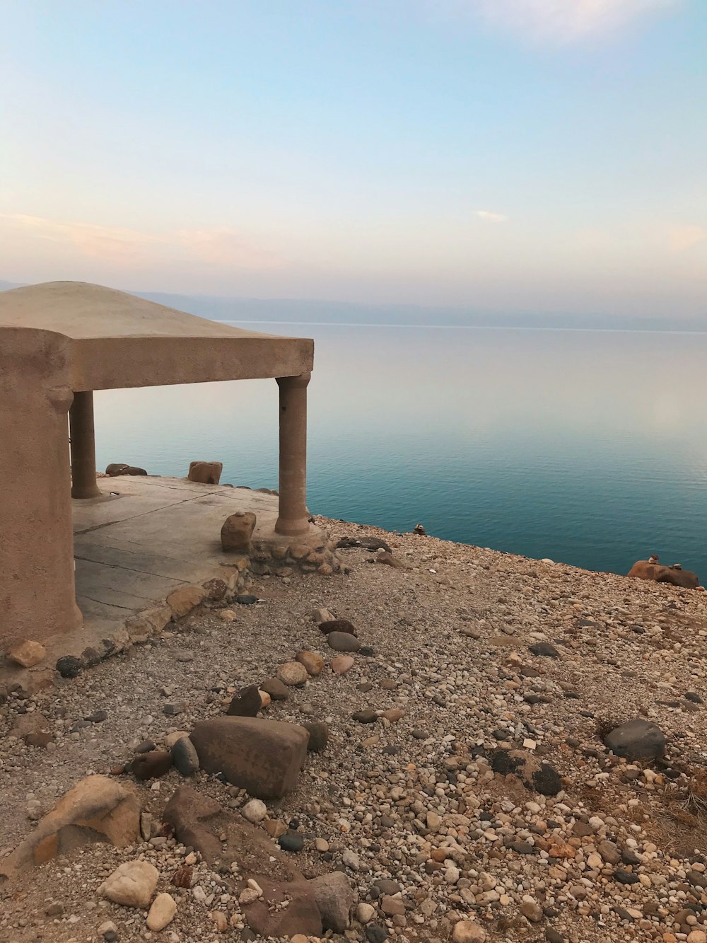 a stone bench sitting on top of a rocky hillside