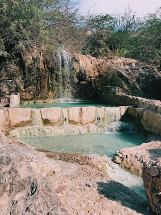 view photography of pond and waterfalls