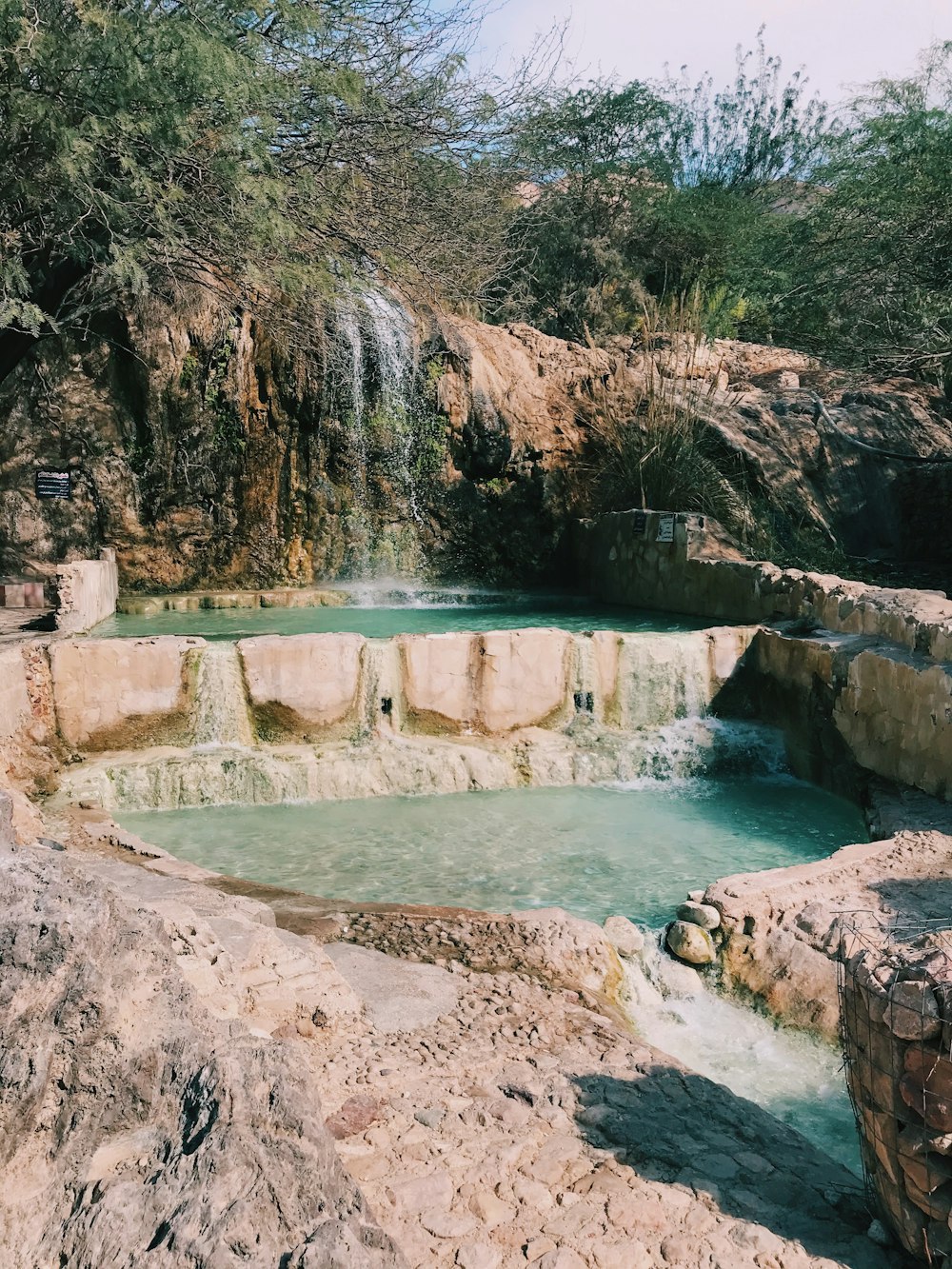 view photography of pond and waterfalls