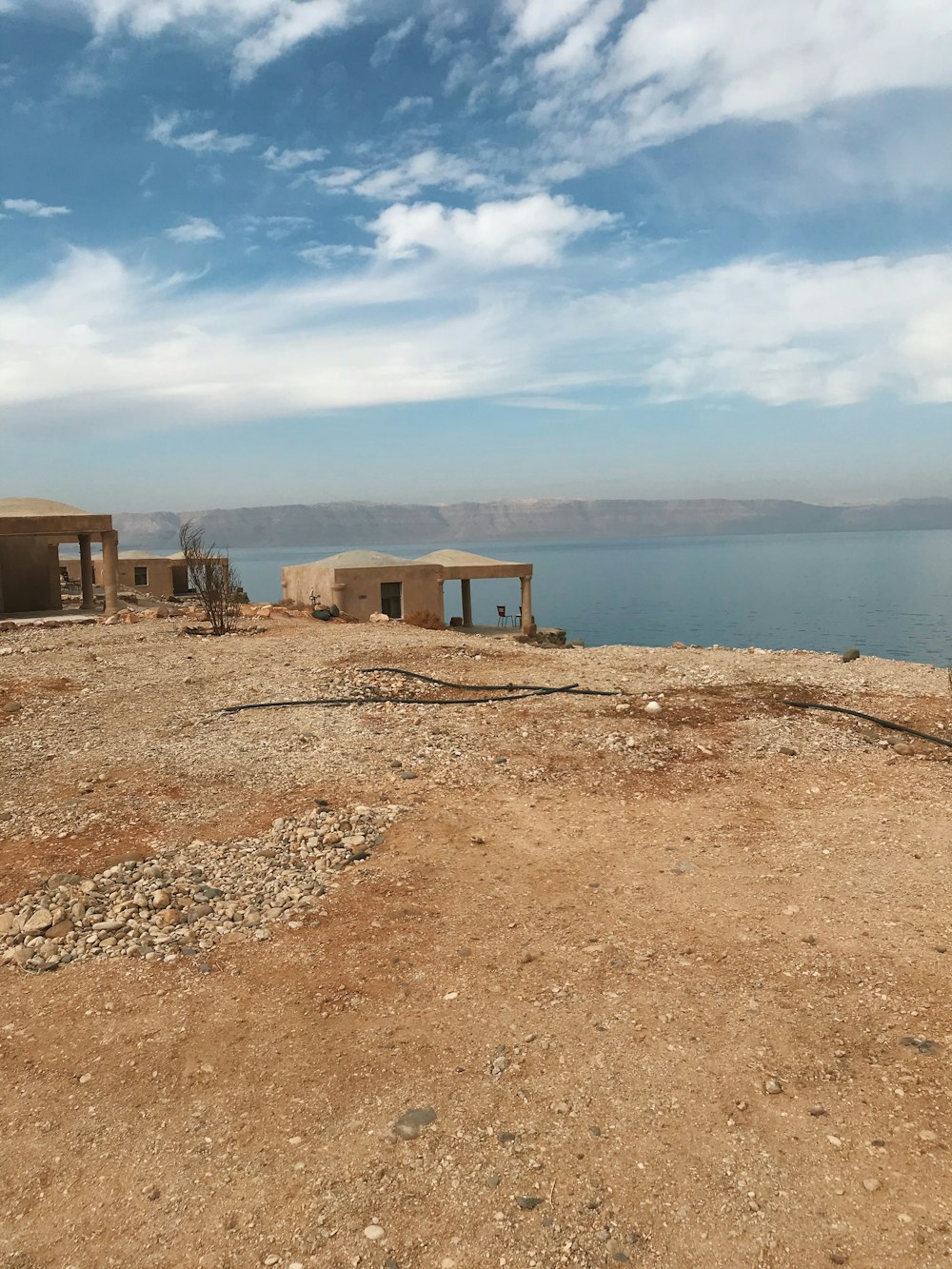 a couple of buildings sitting on top of a dirt hill