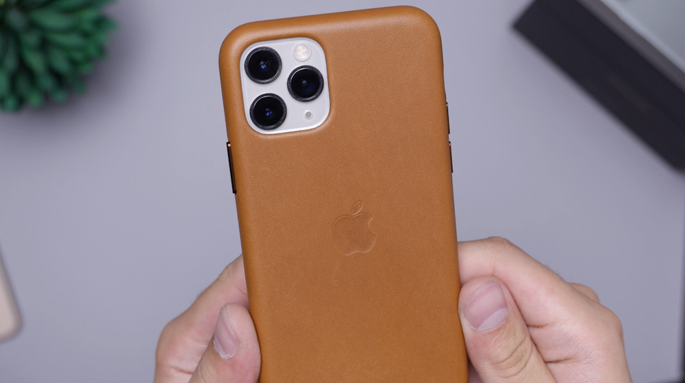 person holding brown iphone case