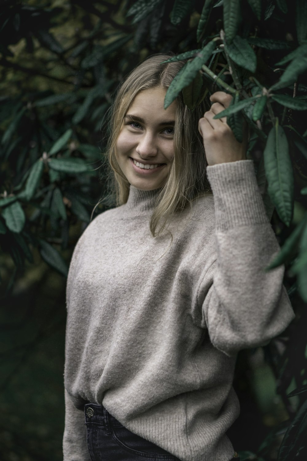 woman standing near green leaf plant