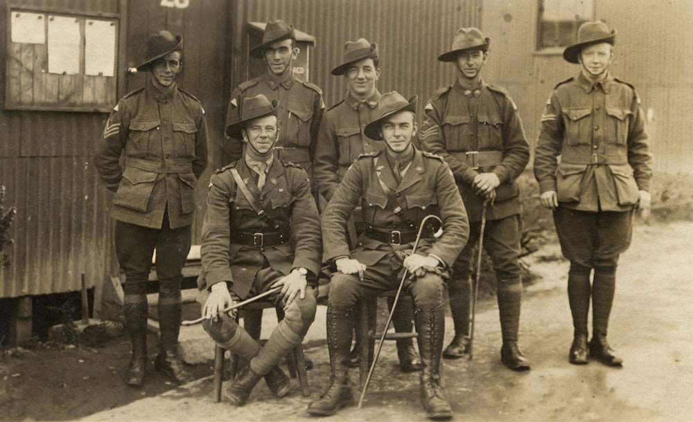 grayscale photo of men holding walk cane