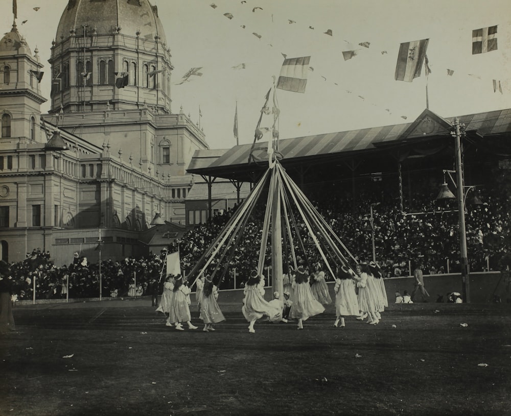 grayscale photography of women going around a merry go round