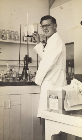 A modern laboratory technician calibrating advanced pharmaceutical testing equipment.
