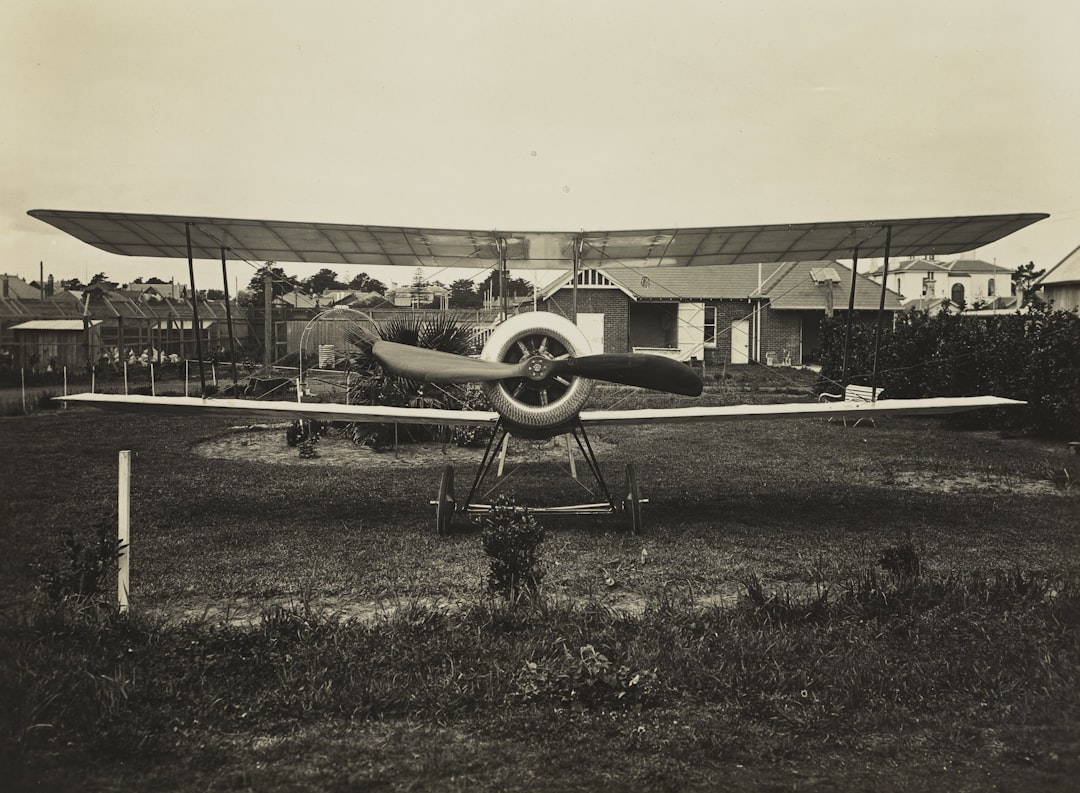grayscale photography of biplane on field, Front View of Basil Watson