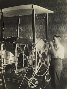 Engineer reviewing a prototype model in a modern workshop setting.