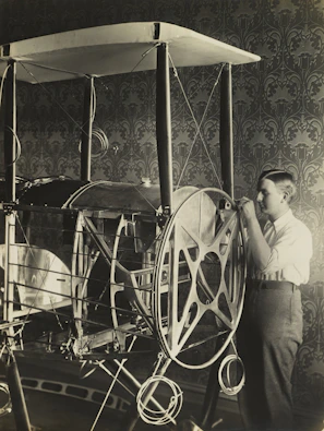 Portrait of a student presenting their aeronautics project in a classroom setting.