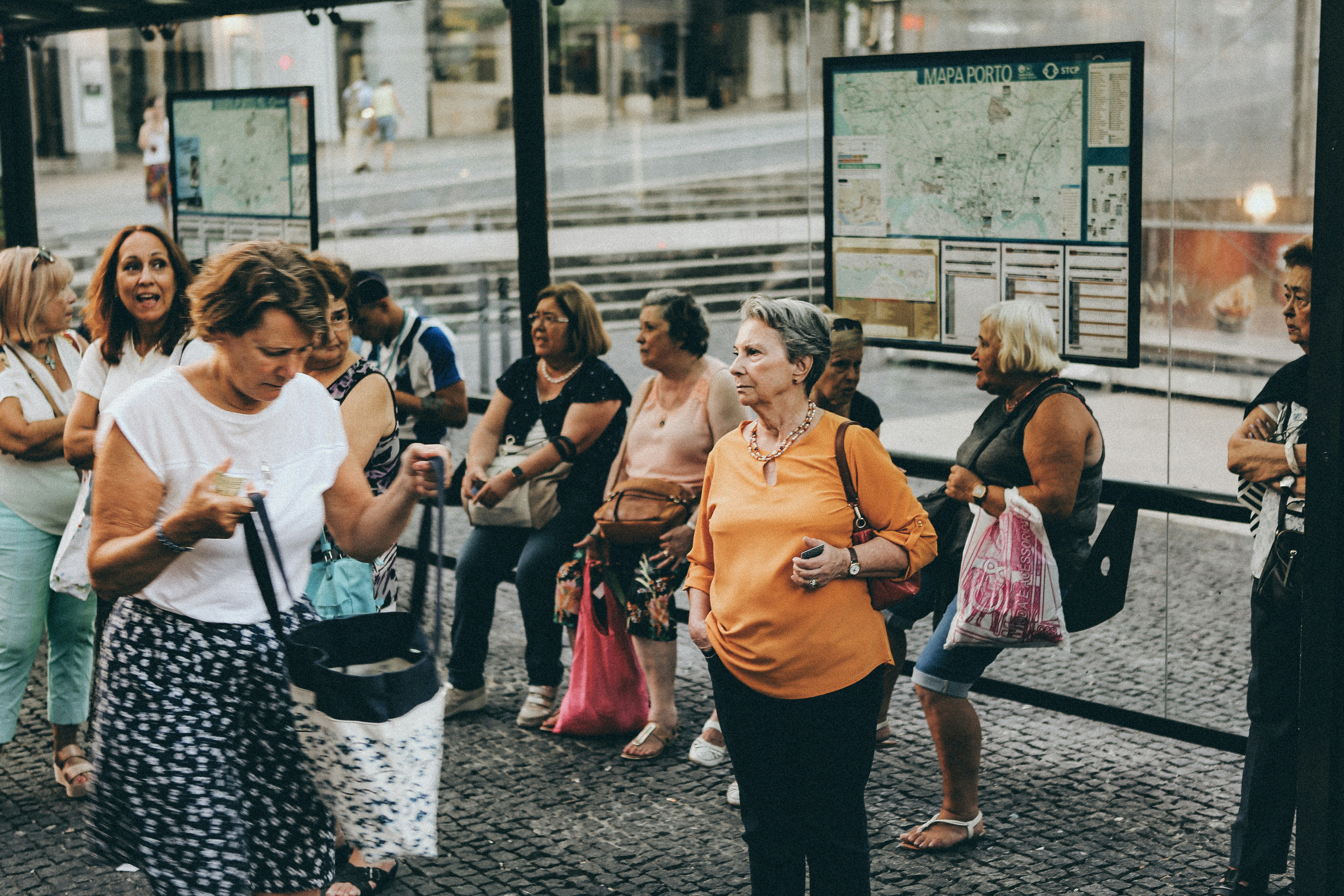 women standing near clear glass store