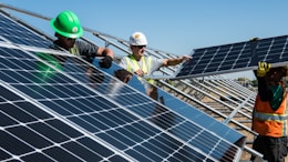men holding solar panels