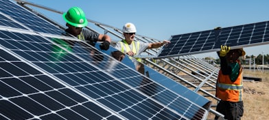 men holding solar panels