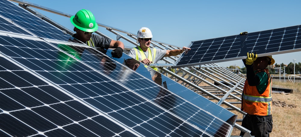 men holding solar panels